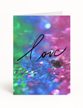 Whole Package love card front with colorful rainbow sparkle design